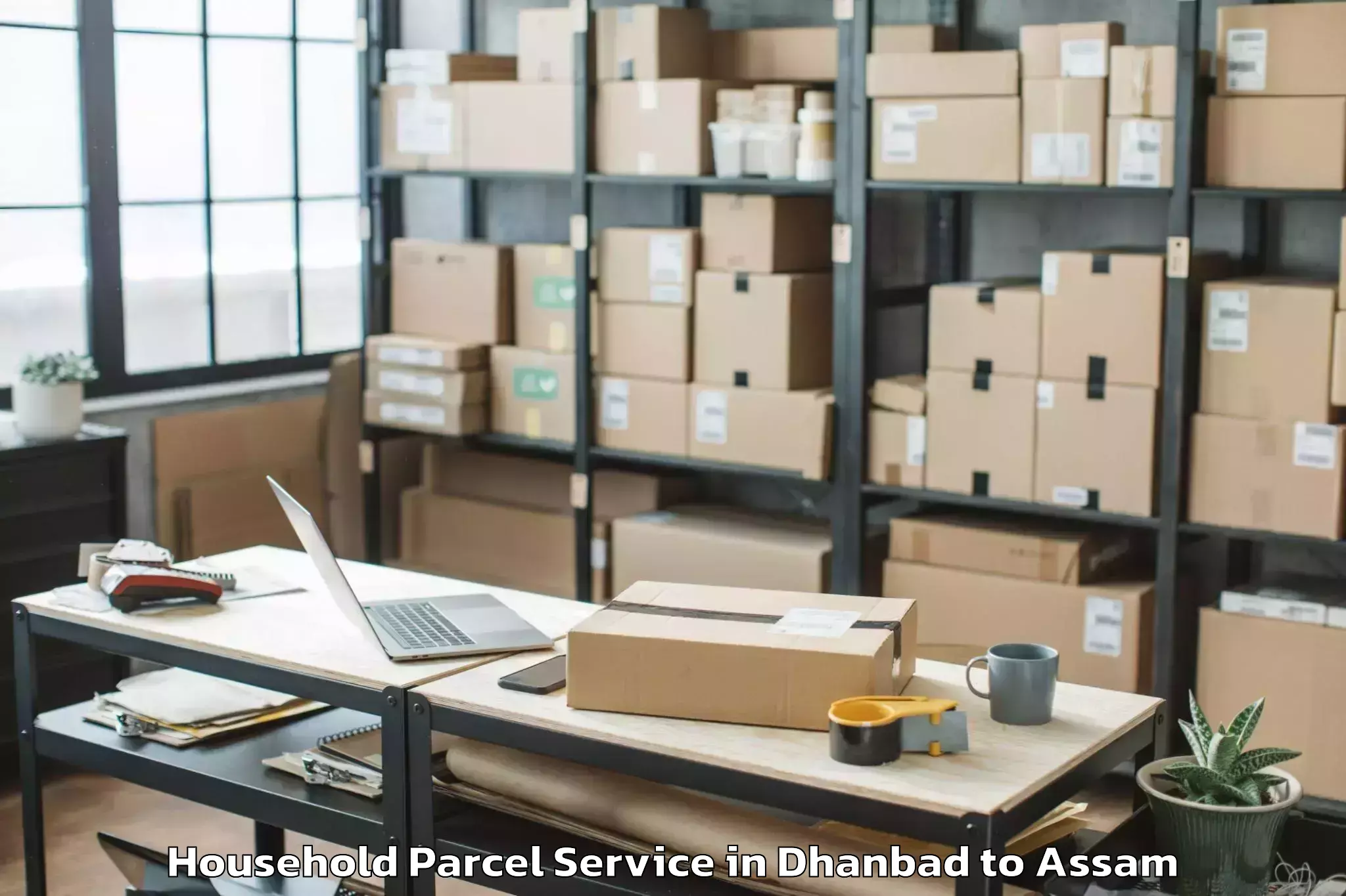 Dhanbad to Kampur Town Household Parcel Booking